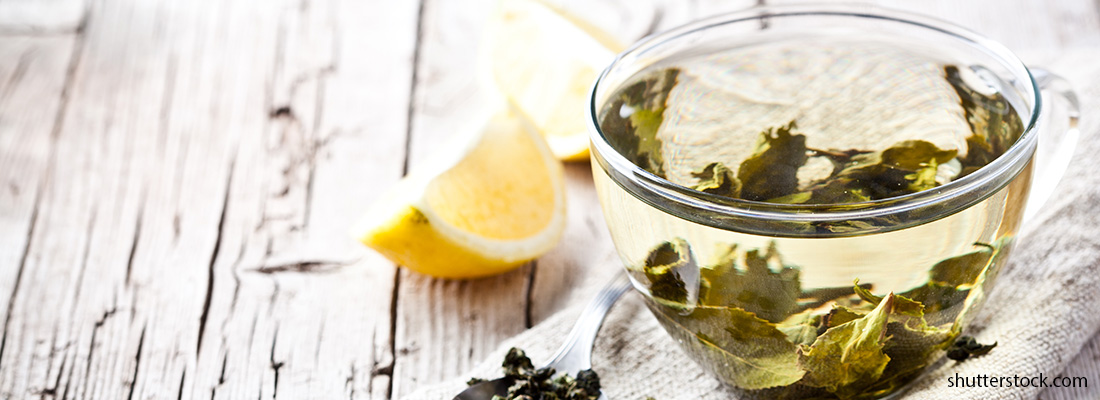 cup-of-green-tea-and-lemon-on-rustic-wooden-table